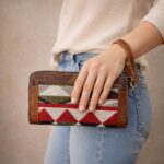 woman holding handcrafted boho leather wallet wristlet